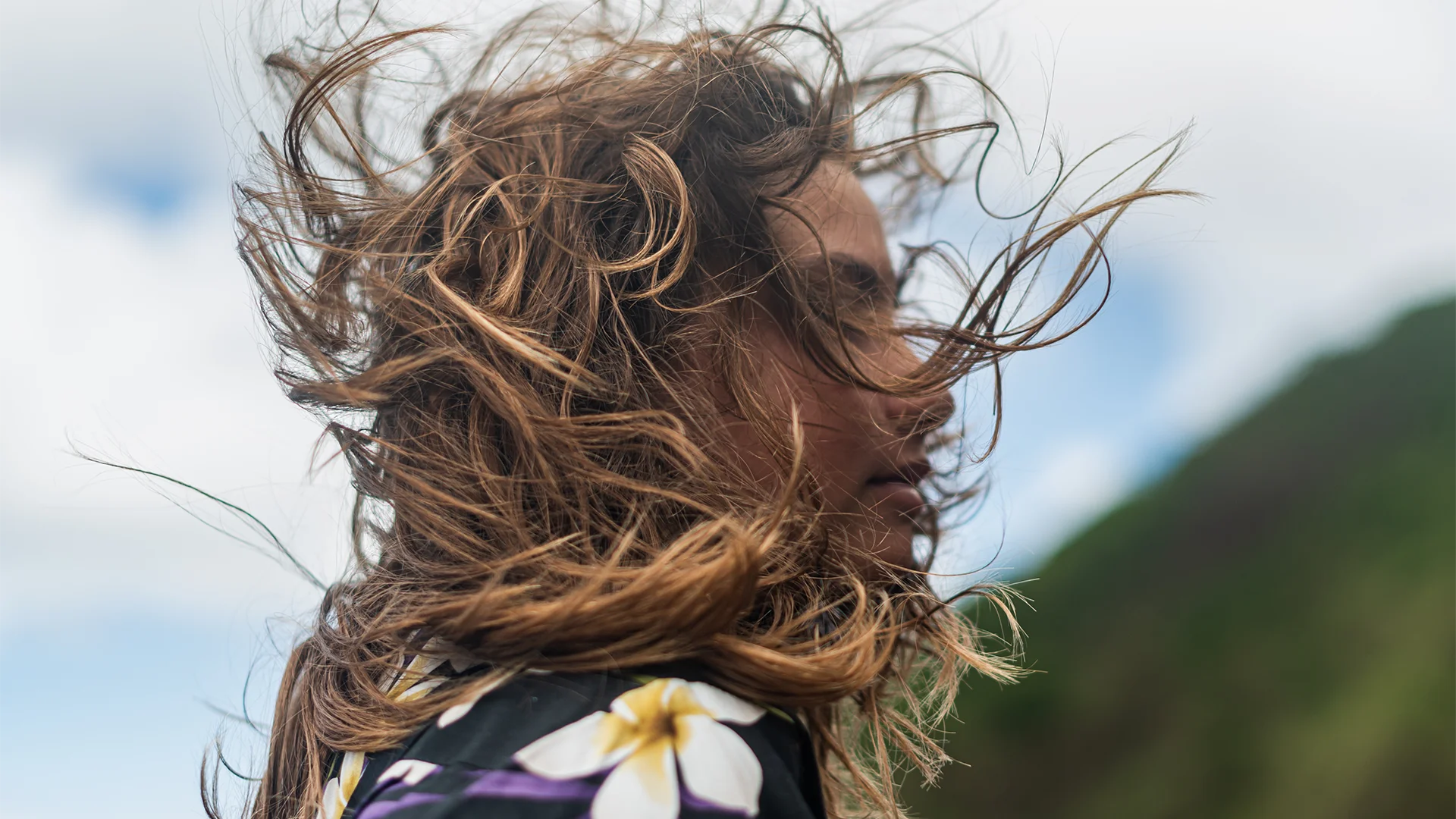 A womans hair flying in the wind (photo)