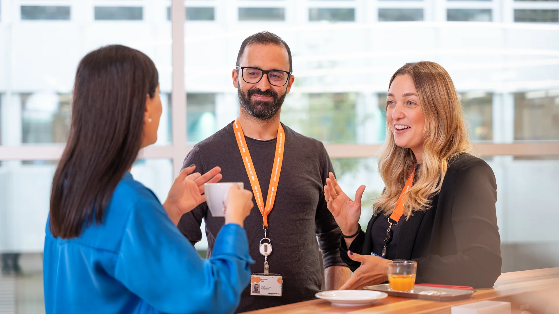 People talking with each other at a standing table (photo)