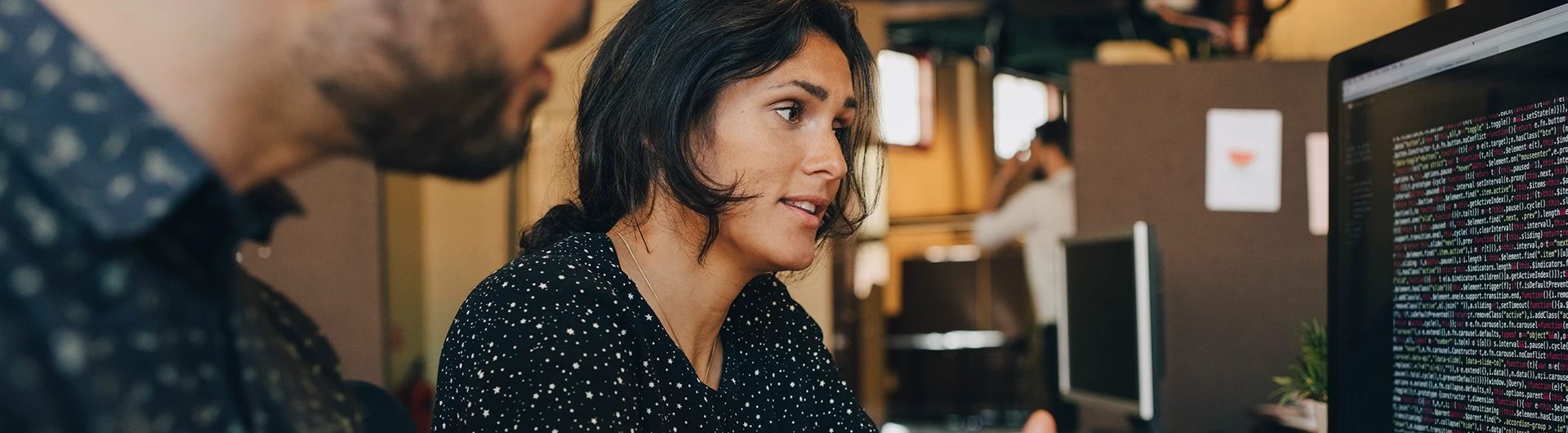 A team reviewing code on screen, focused on data and AI systems. (photo)